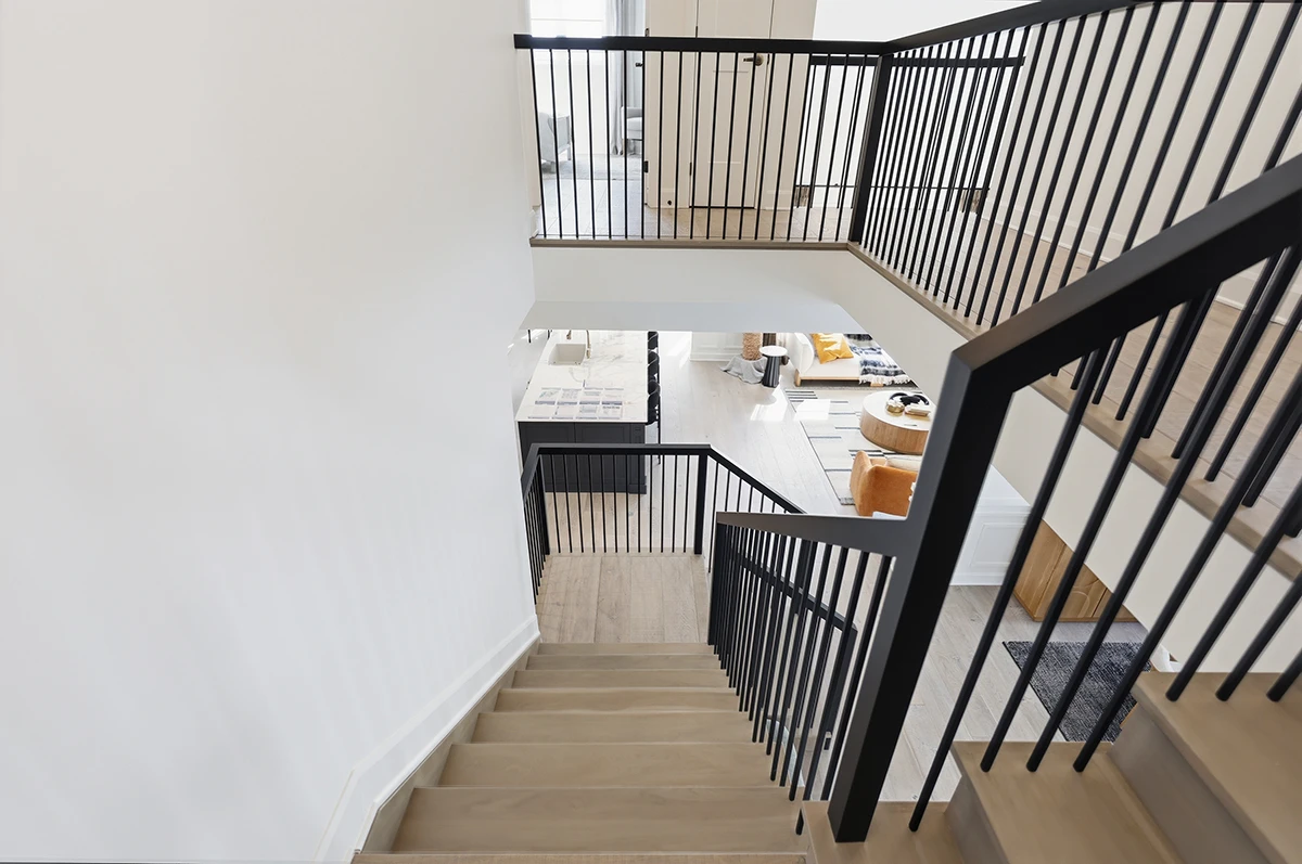 Overhead view of a multi-level staircase with black metal railings.