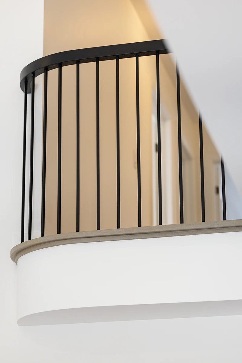 Black metal guardrail on an upper-level landing.