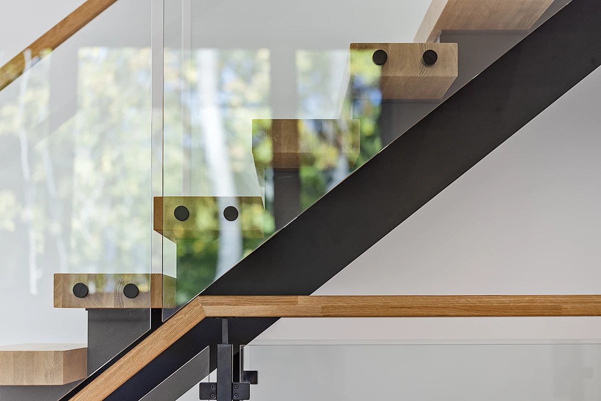Glass railing hardware mounted to a floating staircase.