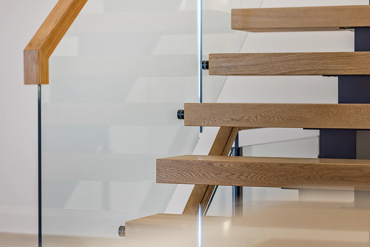 Floating staircase with oak treads viewed from below.