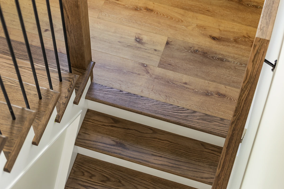 Stair renovation featuring new hardwood treads and flooring.