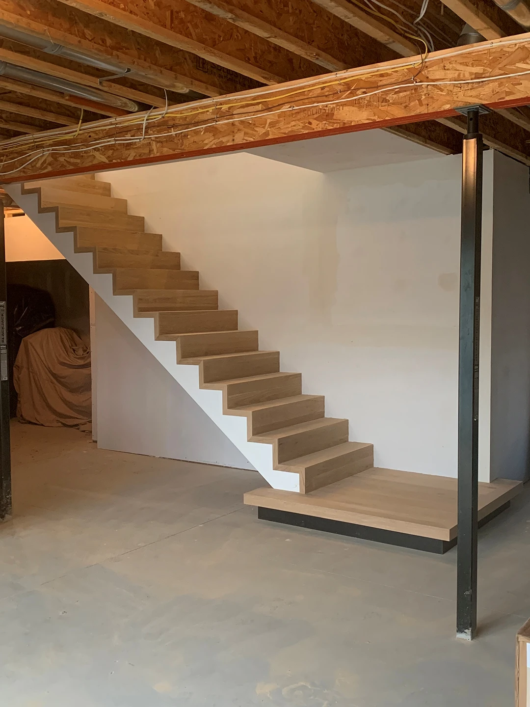 Renovated wood staircase with updated treads and railings.