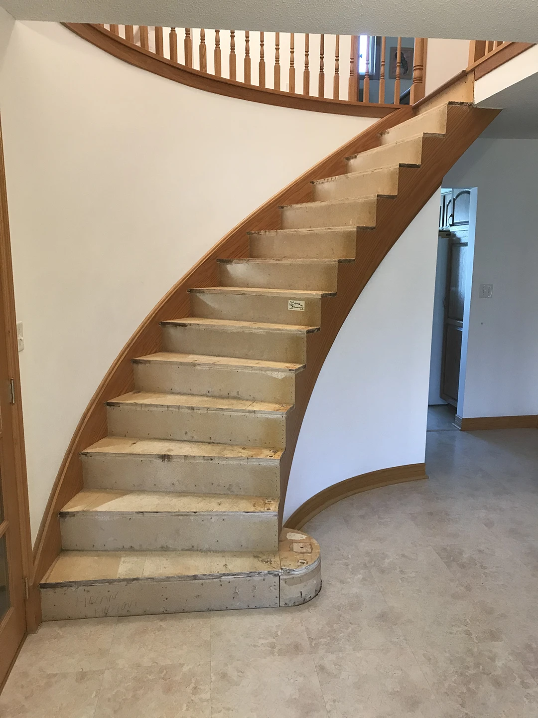 Curved staircase with refinished treads.