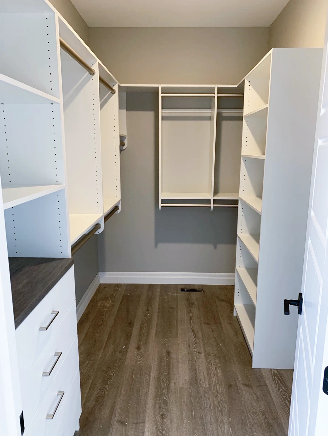 White custom closet system with adjustable shelving.