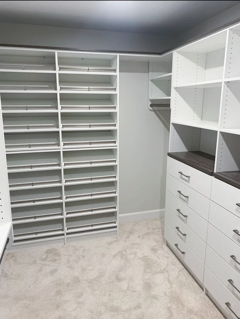 Walk-in pantry with custom shelving and drawer storage.