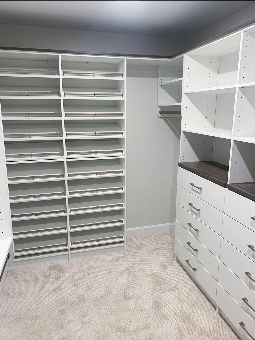 Walk-in pantry with custom shelving and drawer storage.