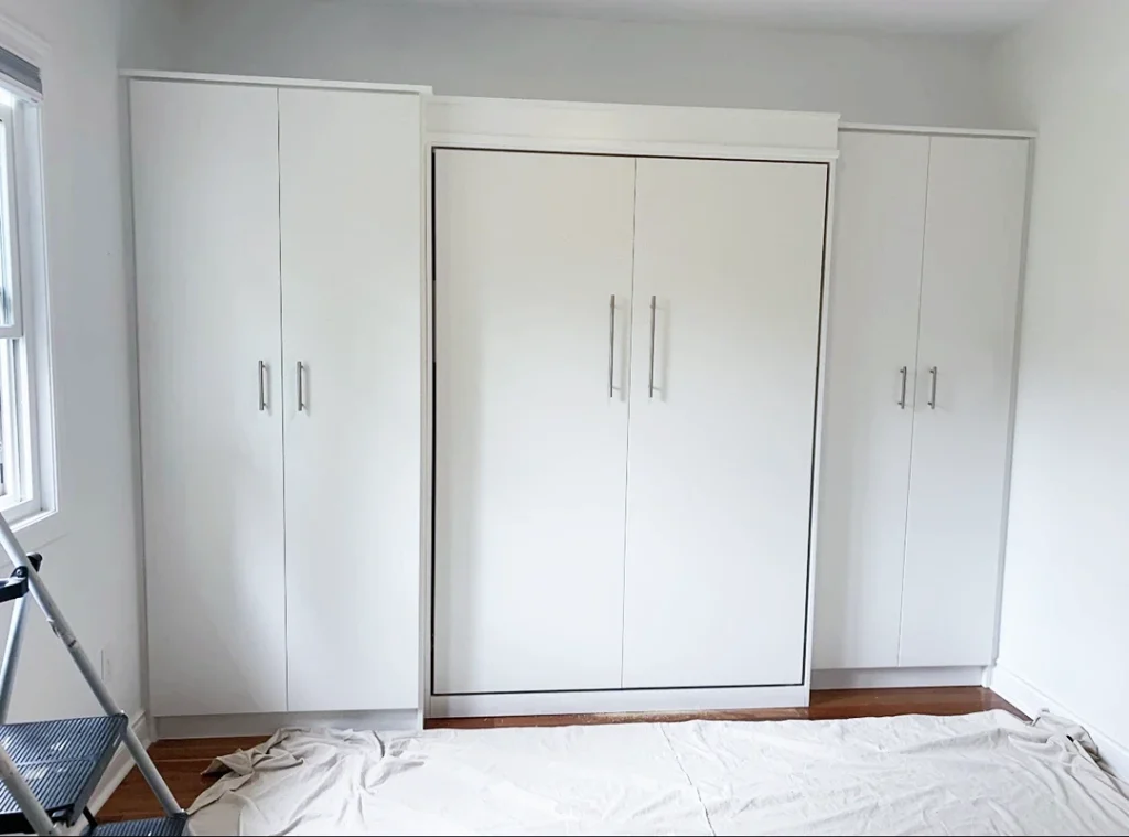 Custom white closet storage system with built-in cabinetry.